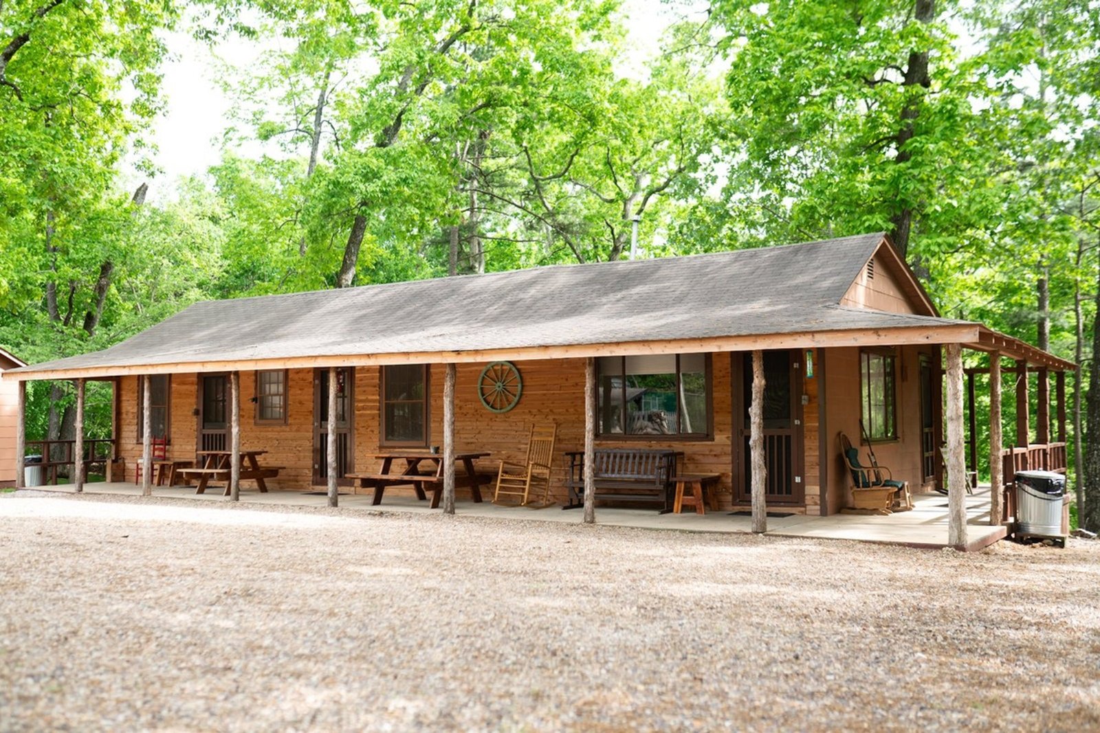 View of Cabin 2 at Sunset Point Resort surrounded by trees and lake